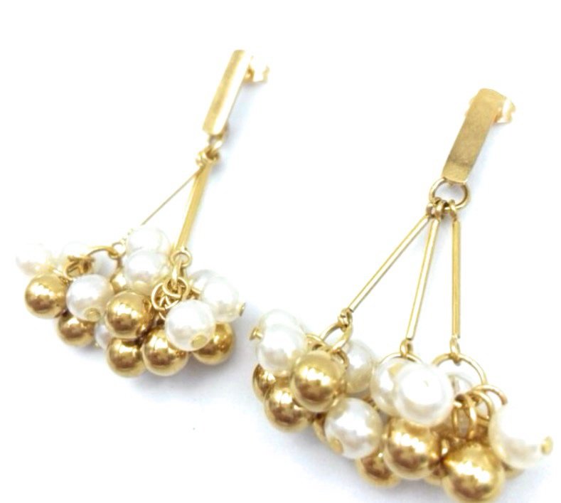 Gold-toned cluster pearl drop earrings featuring delicate chains and lustrous pearl beads
